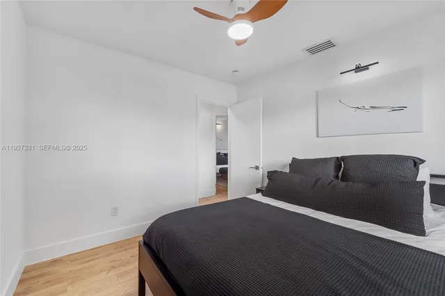 a bedroom with a bed and a ceiling fan