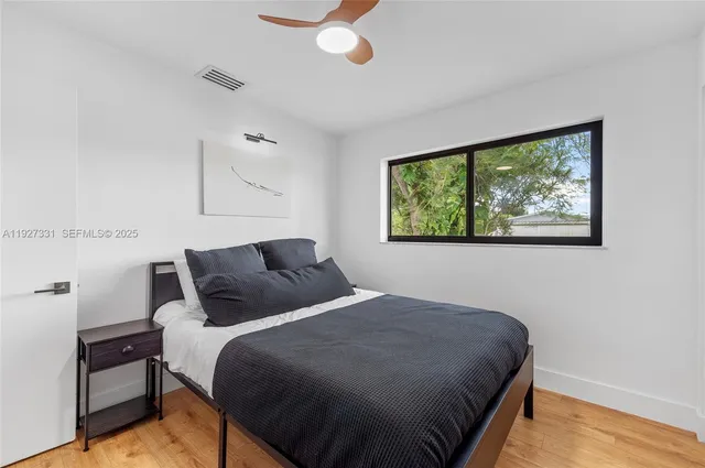 a bedroom with a bed and window