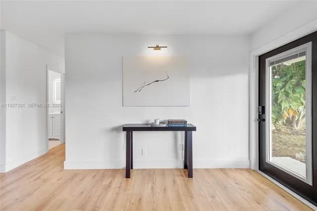 a view of a room with wooden floor and a window
