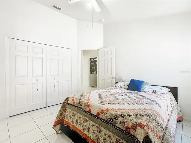 a spacious bedroom with a bed and a shower