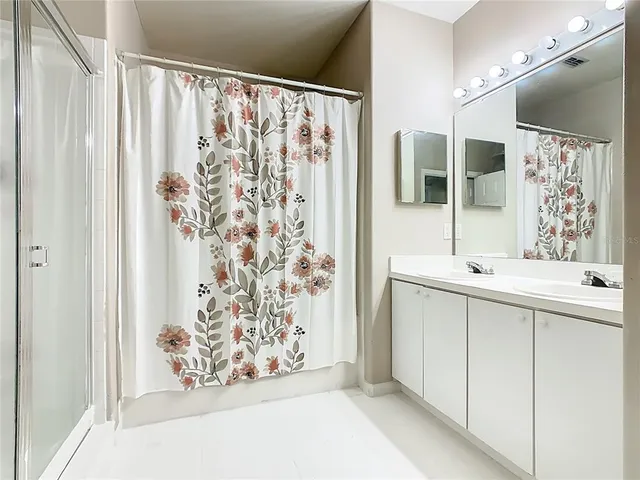 a bathroom with a double vanity sink and mirror