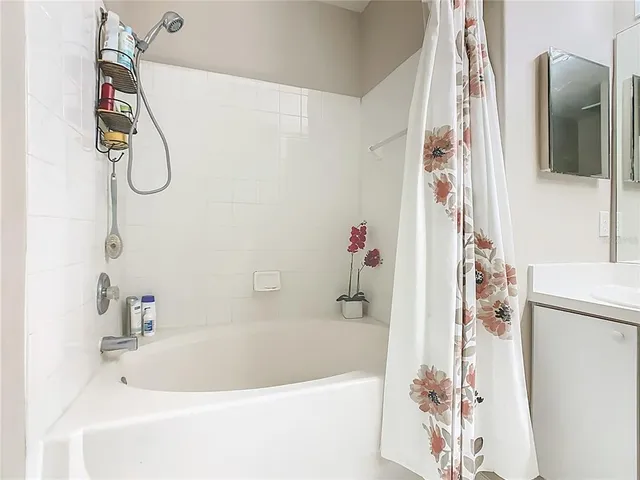 a bathroom with a tub and a shower curtain