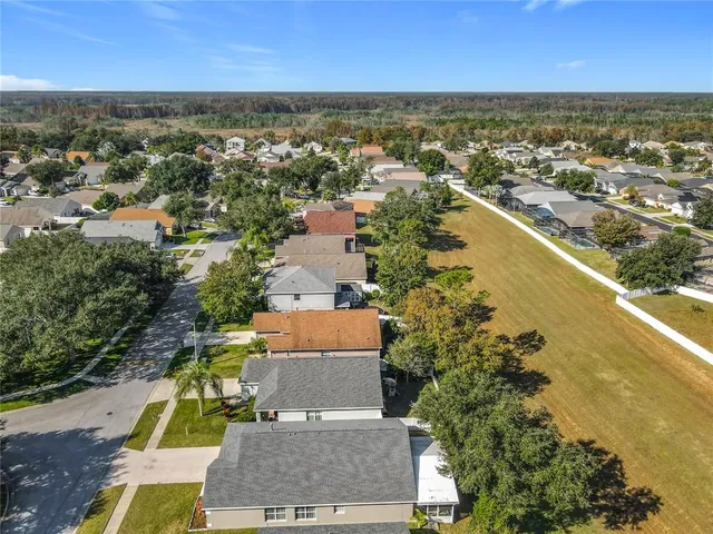 an aerial view of residential houses with outdoor space and river