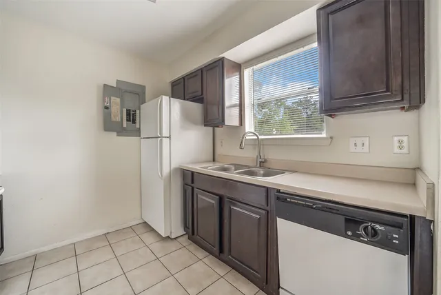 a kitchen with a sink cabinets and appliances