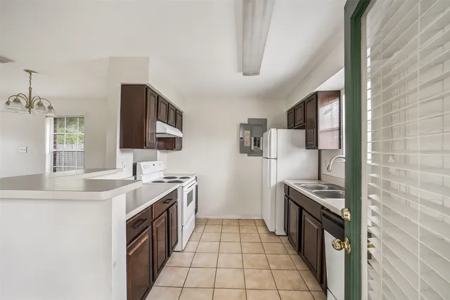 a kitchen with stainless steel appliances a sink stove and refrigerator