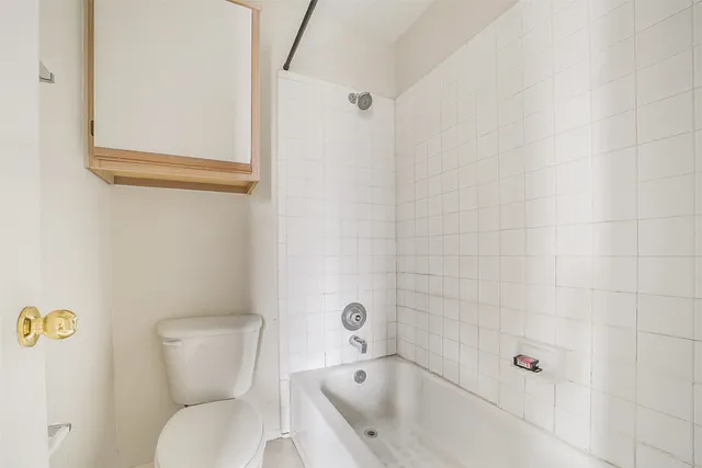 a bathroom with a toilet and shower
