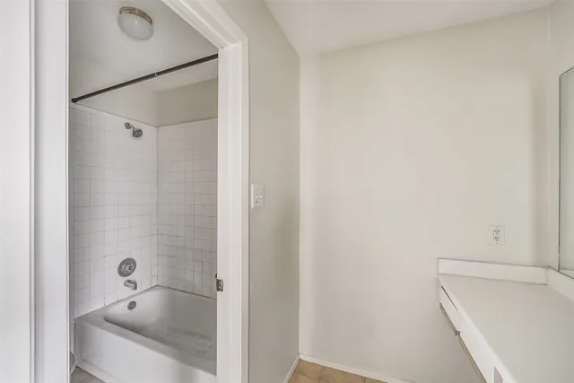 a bathroom with a tub and shower