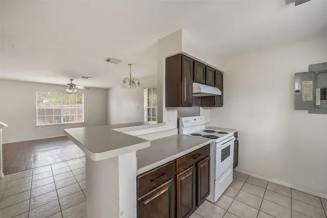 a kitchen that has a sink and a stove in it