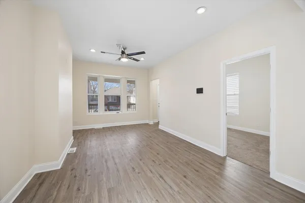 wooden floor in an empty room with a window