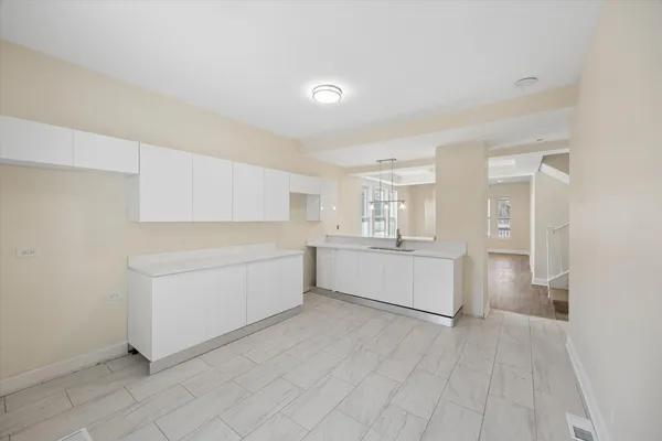 a kitchen with white cabinets and white appliances