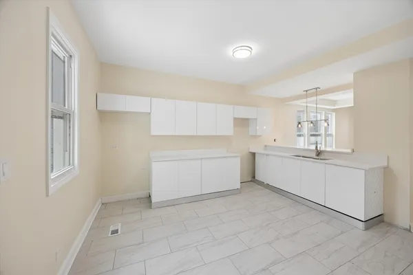 a kitchen with a white stove refrigerator and cabinets