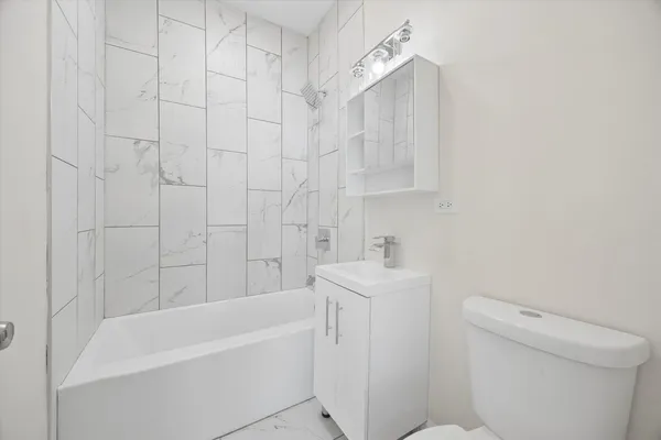 a bathroom with a sink a toilet and bathtub