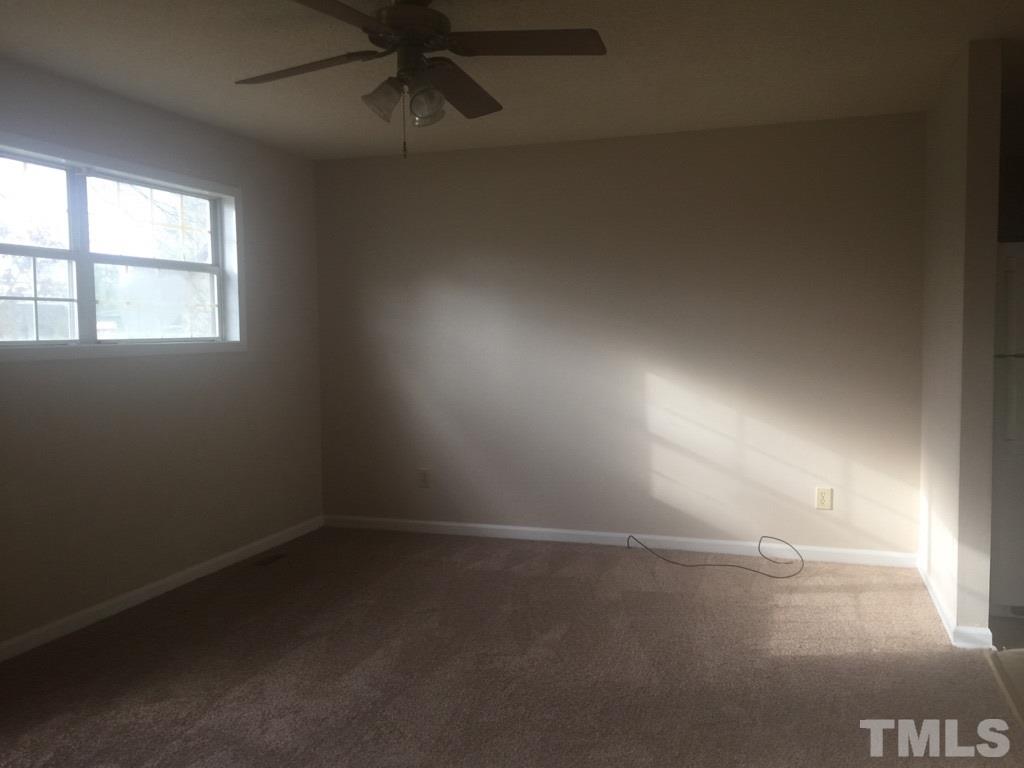 735 North Main Street Wake Forest, NC 27587 - Photo 2 of 5 wooden floor in an empty room with a window