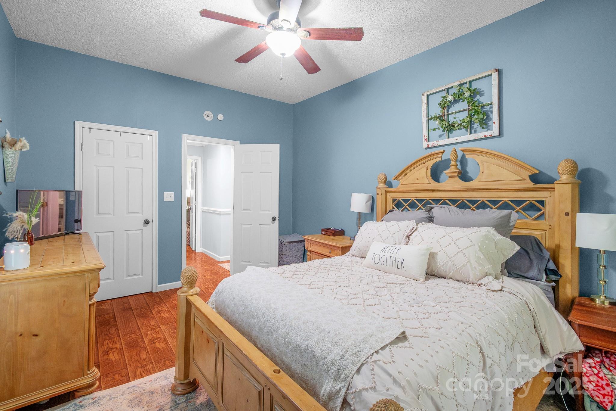 2578 Laboratory Road Lincolnton, NC 28092 - Photo 16 of 34 a bedroom with a bed and a chandelier