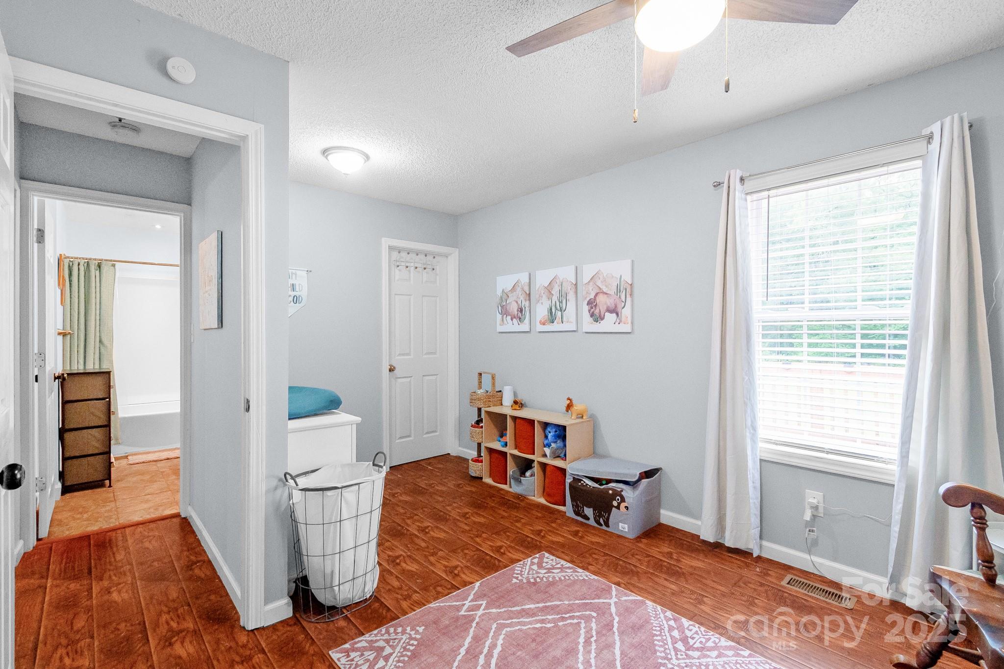 2578 Laboratory Road Lincolnton, NC 28092 - Photo 22 of 34 a bedroom with furniture and a wooden floor