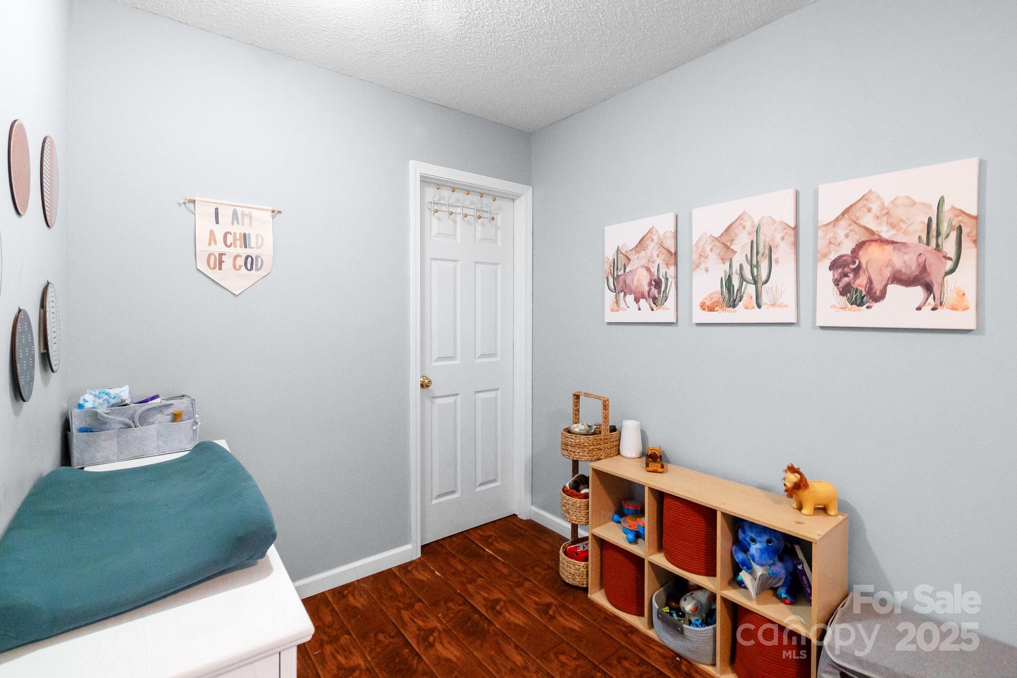 2578 Laboratory Road Lincolnton, NC 28092 - Photo 23 of 34 a bedroom with furniture and a book shelf