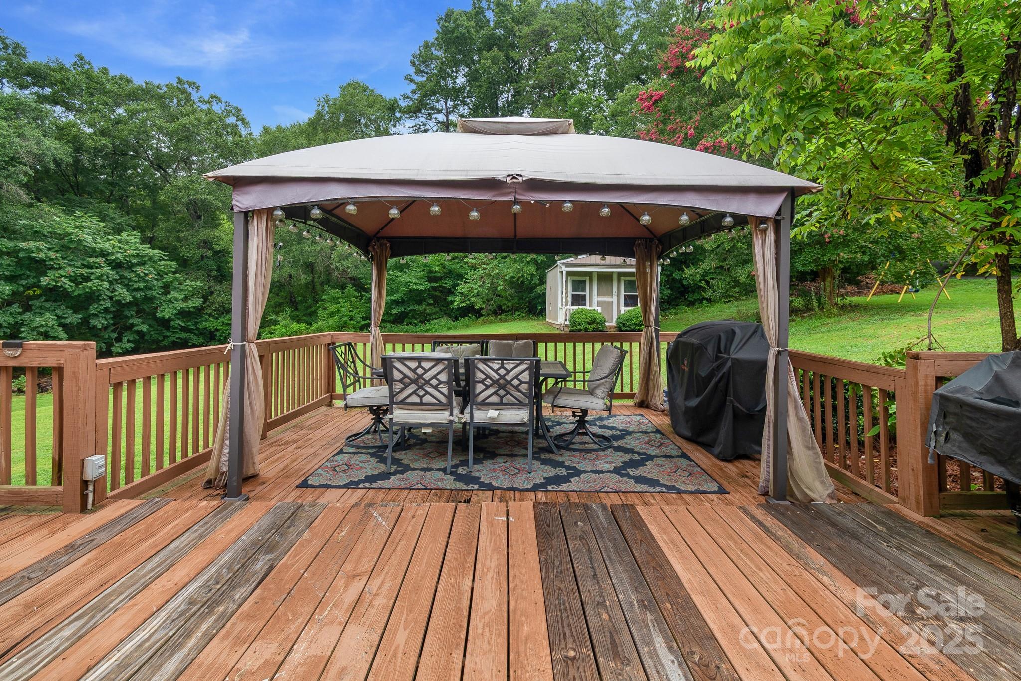 2578 Laboratory Road Lincolnton, NC 28092 - Photo 29 of 34 a view of a patio with table and chairs under an umbrella with wooden floor