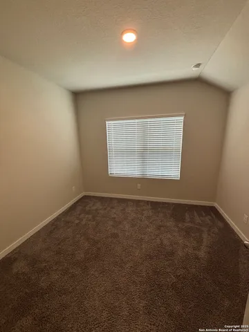 an empty room with a empty space and windows