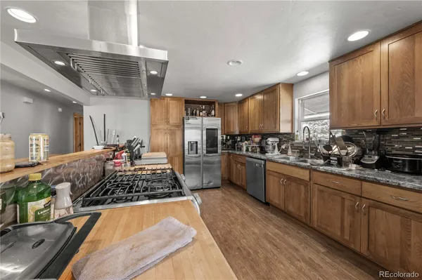 a kitchen with a stove sink and cabinets