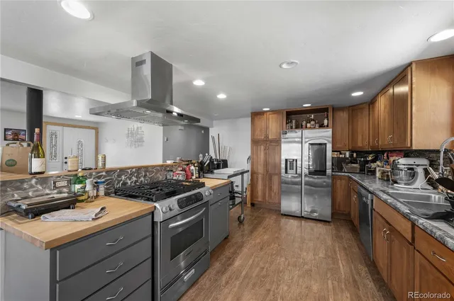 a kitchen with a stove a refrigerator and a sink