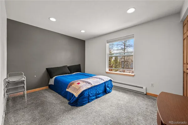 a bedroom with furniture and a window