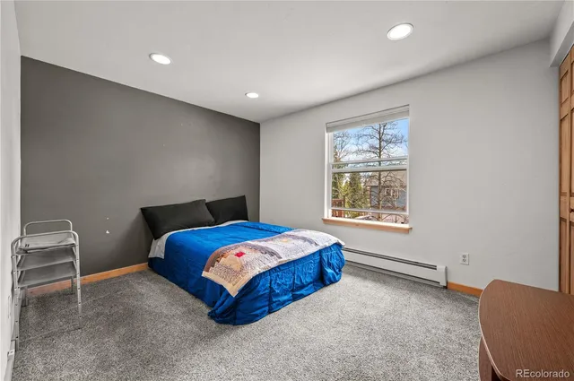 a bedroom with furniture and a window