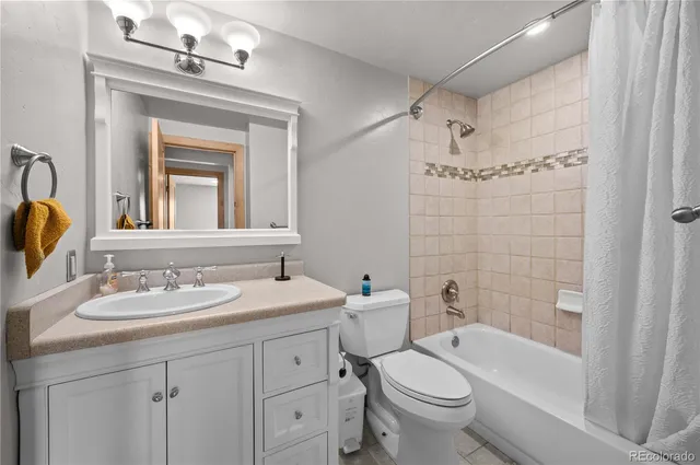 a bathroom with a sink vanity and a mirror