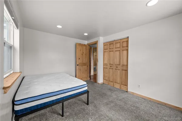 a bed sitting in a bedroom next to a window