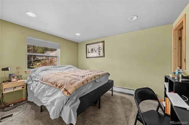 a bedroom with a large bed and a window