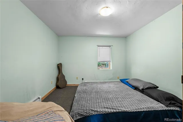 a bedroom with a bed and dresser