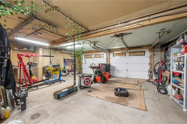 a view of a backyard with table and chairs and a large tree