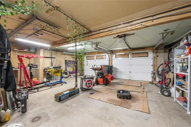 a view of a backyard with table and chairs and a large tree