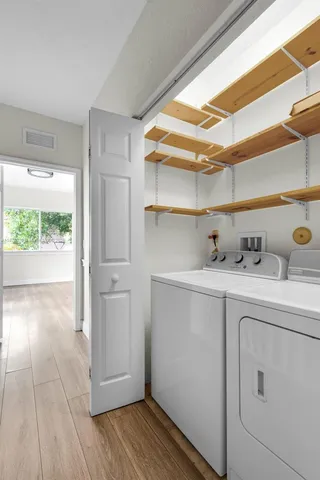 a view of storage and utility room with washer and dryer