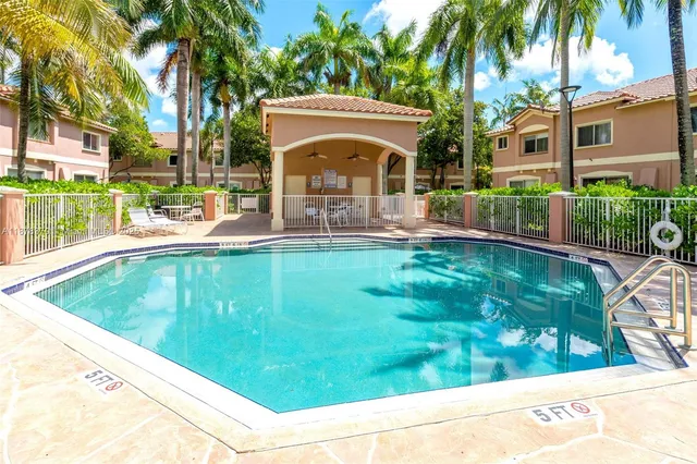 a view of a house with a yard balcony and a swimming pool
