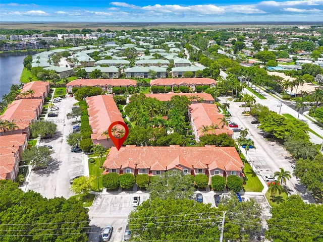an aerial view of residential houses with outdoor space and river