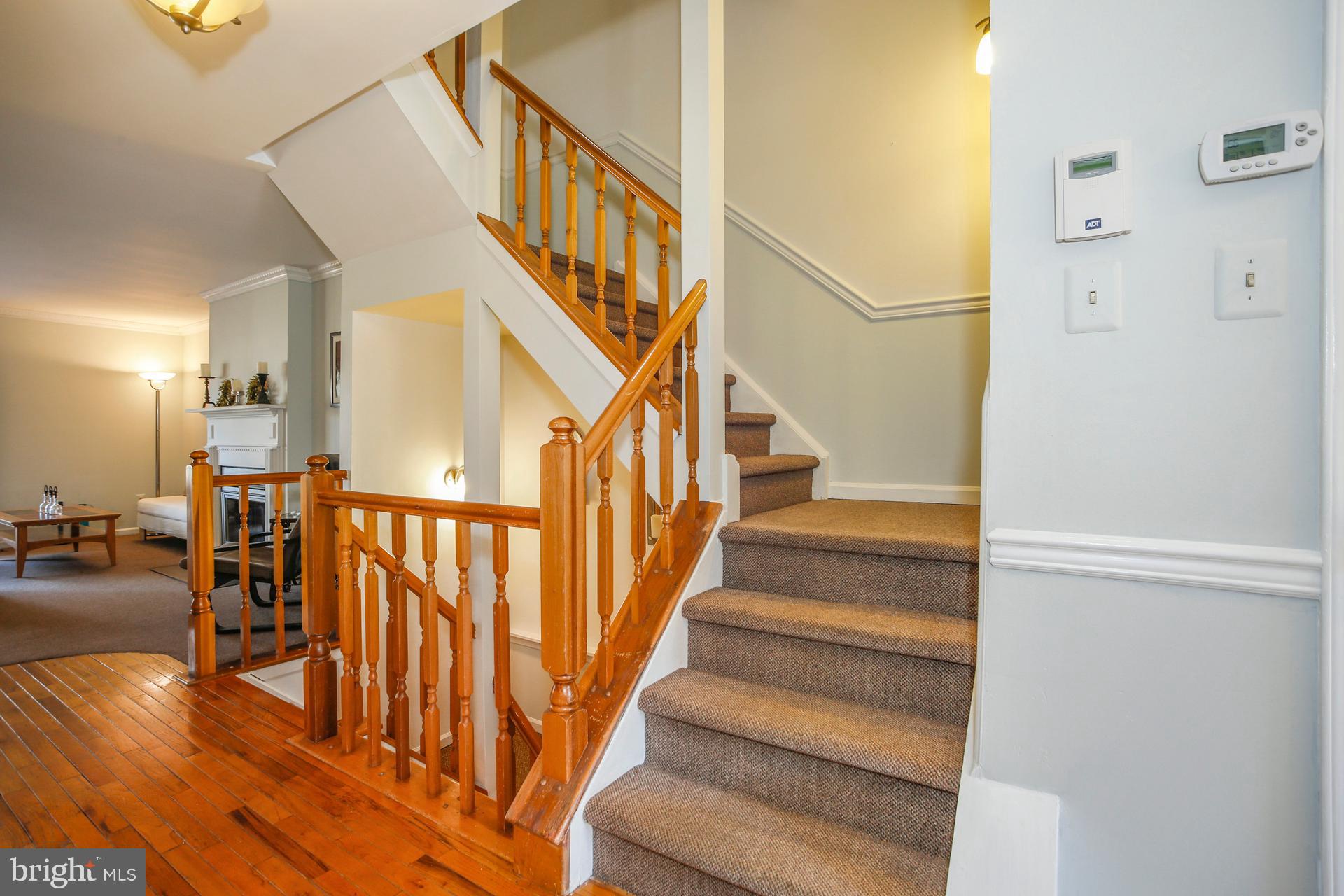 45 Main Street Chesterbrook, PA 19087 - Photo 13 of 36 a view of staircase with lots of frames on wall and a dining table