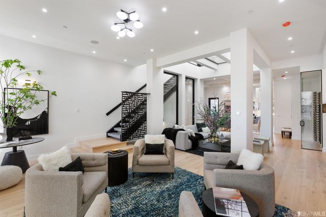 a living room with furniture and a chandelier