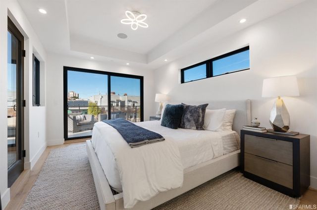 a bedroom with bed and a large mirror