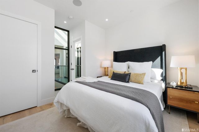 a bedroom with a bed and a night stand