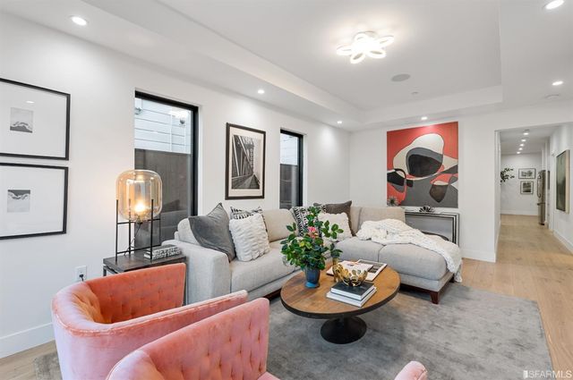 a living room with furniture and a potted plant