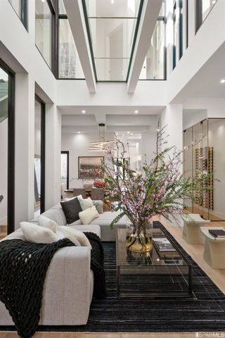 a living room with patio furniture and a chandelier