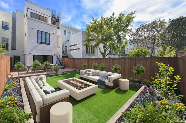 a view of a patio with couches chairs and a fire pit