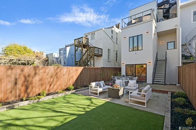 a view of a patio with table and chairs with wooden floor and fence