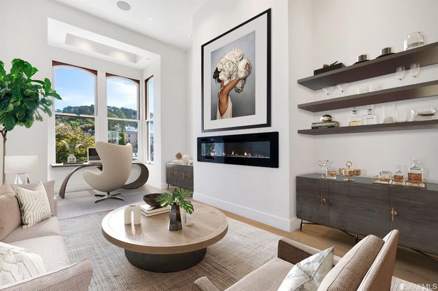 a living room with furniture and a potted plant
