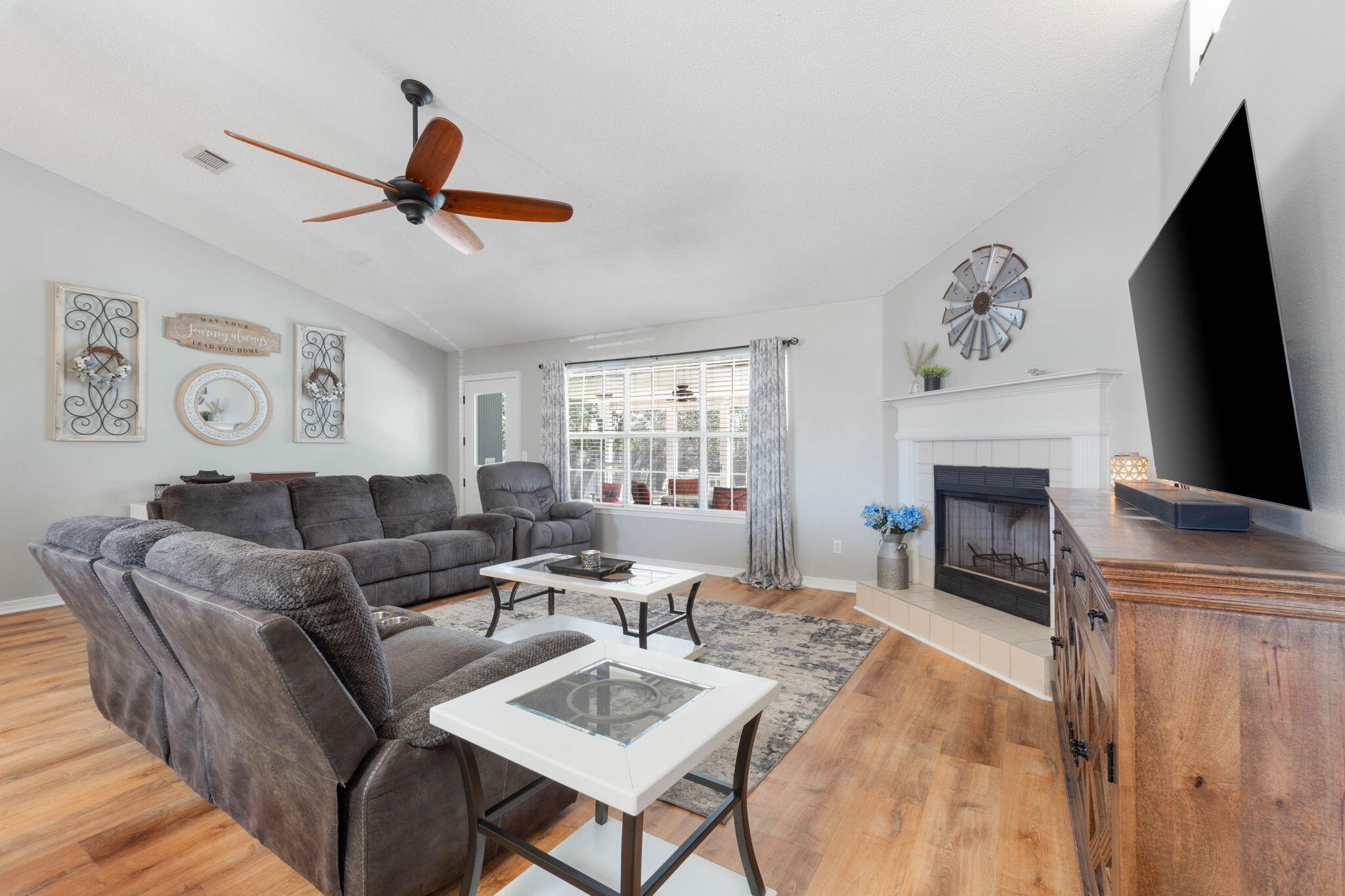 6779 Cedar Ridge Circle Milton, FL 32570 - Photo 10 of 46 a living room with furniture a fireplace and a flat screen tv