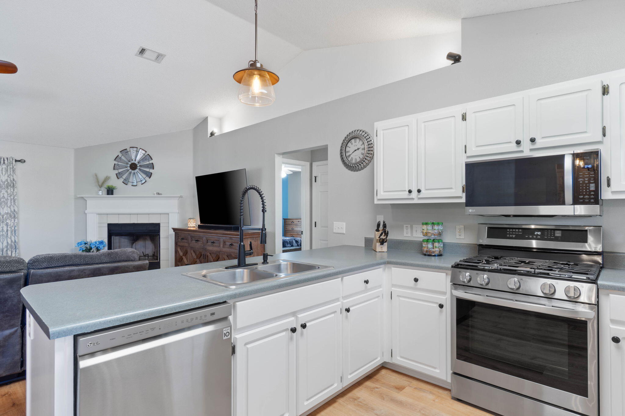 6779 Cedar Ridge Circle Milton, FL 32570 - Photo 15 of 46 a kitchen with a sink stove and microwave