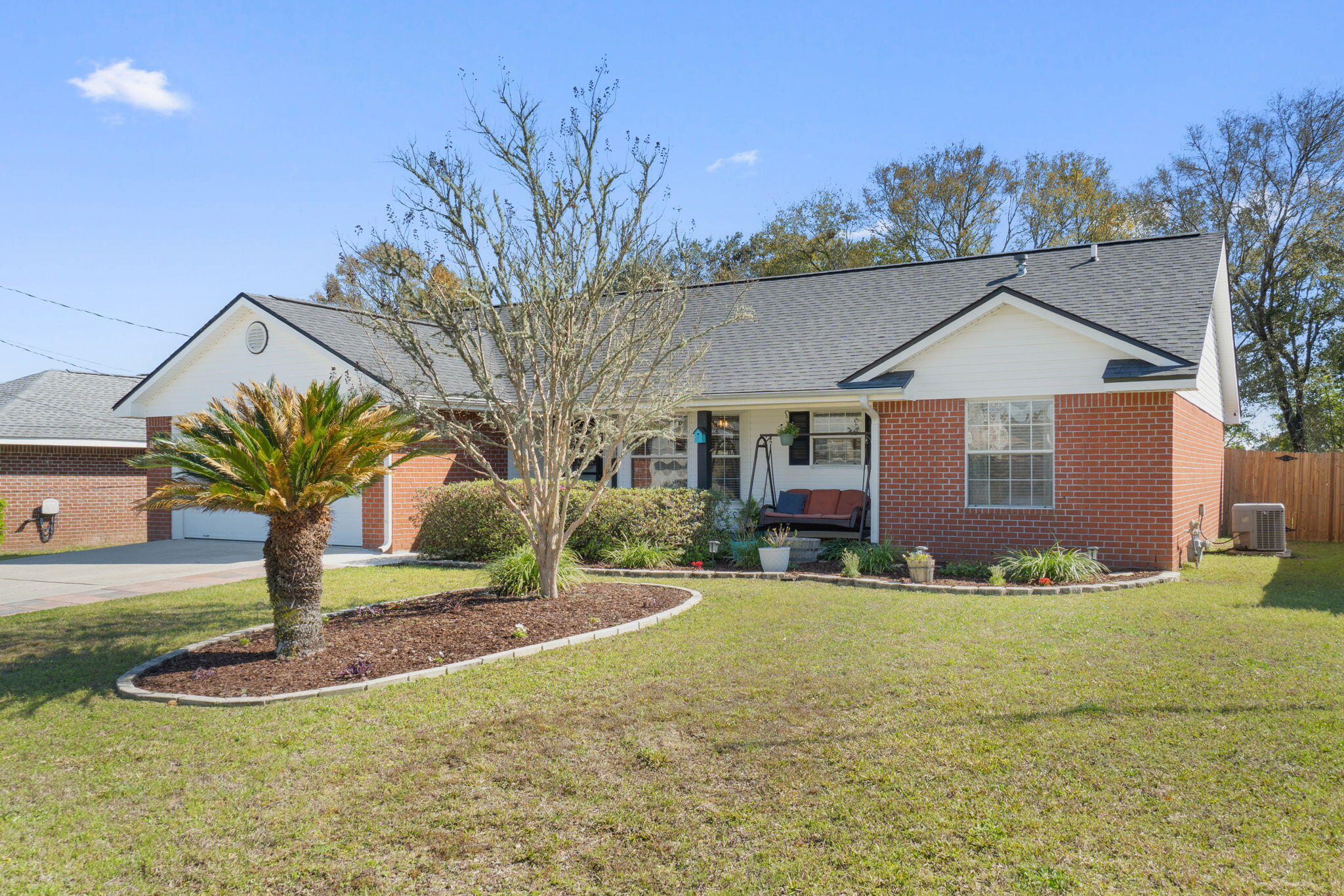 6779 Cedar Ridge Circle Milton, FL 32570 - Photo 2 of 46 a front view of a house with a yard
