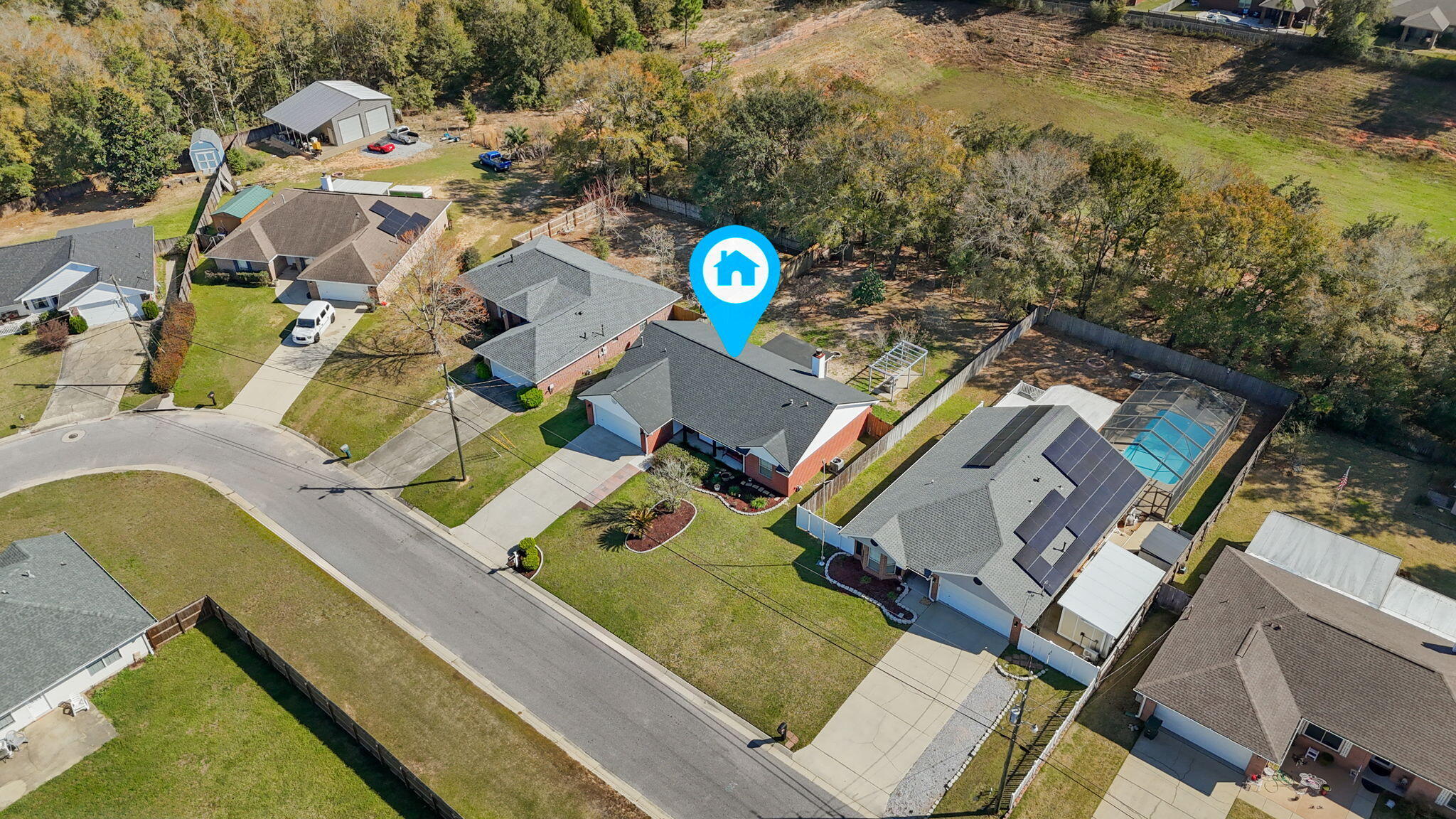 6779 Cedar Ridge Circle Milton, FL 32570 - Photo 36 of 46 an aerial view of a house with a swimming pool