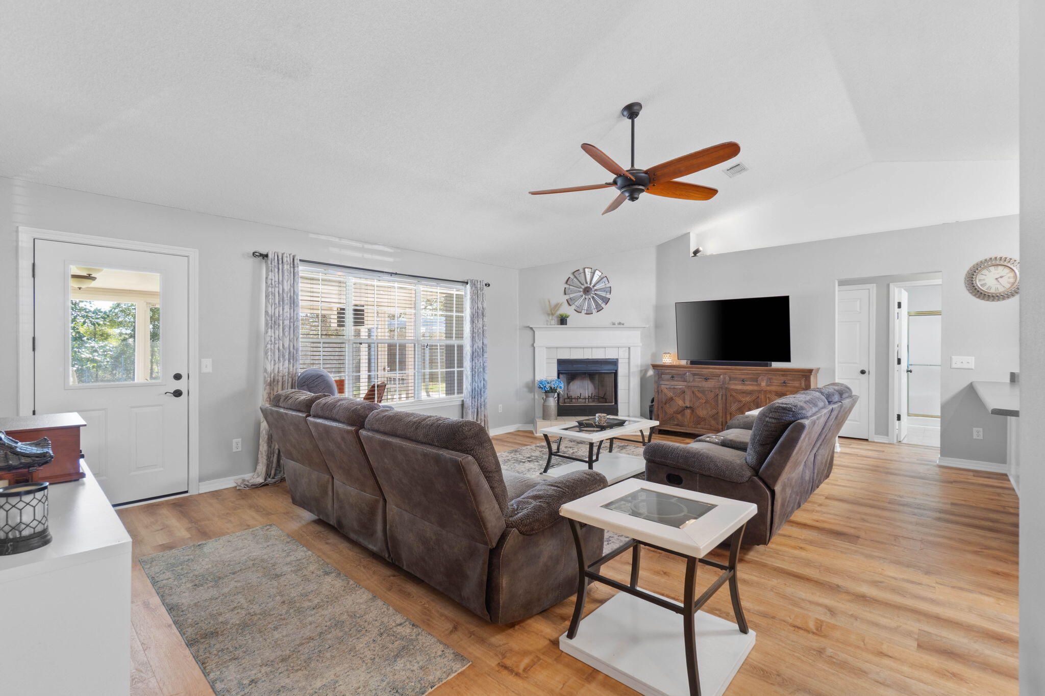 6779 Cedar Ridge Circle Milton, FL 32570 - Photo 8 of 46 a living room with furniture a flat screen tv and a fireplace