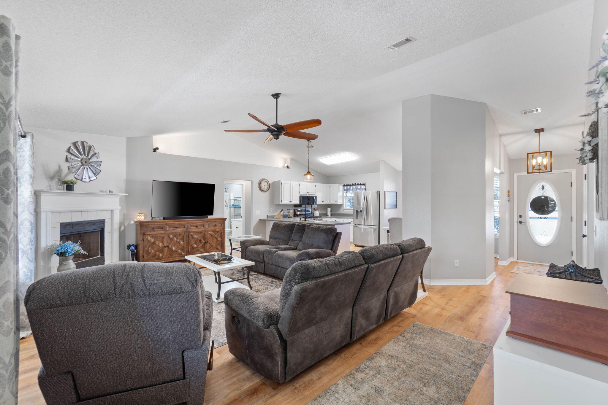 6779 Cedar Ridge Circle Milton, FL 32570 - Photo 9 of 46 a living room with furniture a fireplace and a flat screen tv
